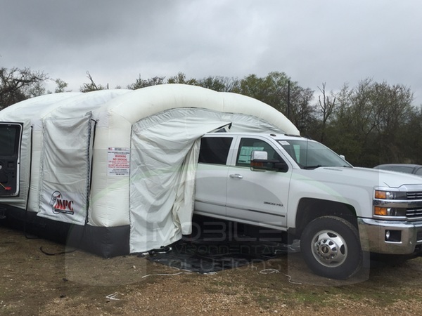 bedliner booth with white truck